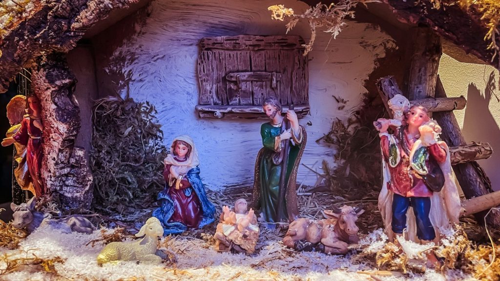 Nativity scene with figurines in a stable setting